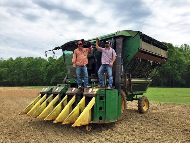 Men Standing On Combine